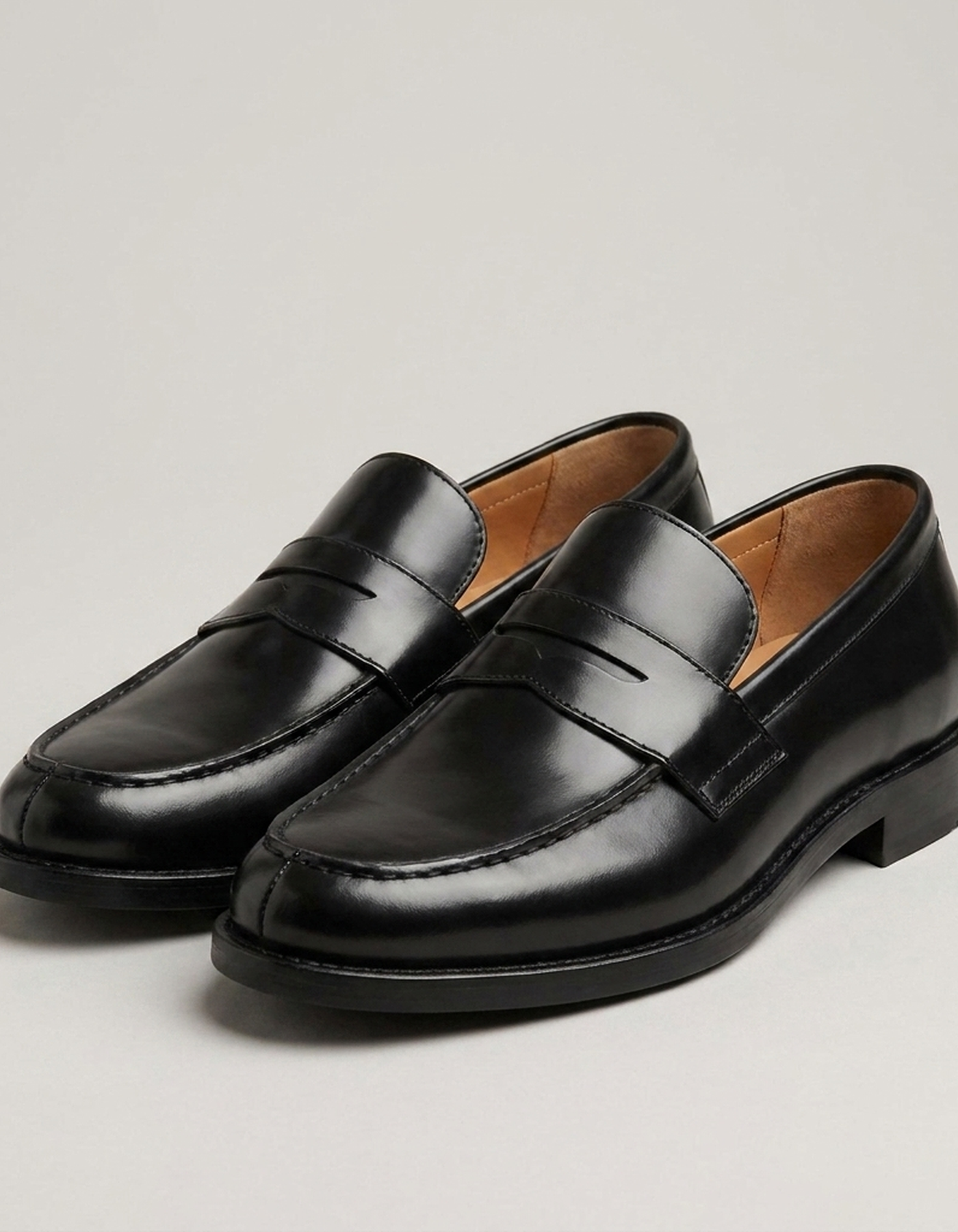 PLUXSTYLE::numise::mens-black-penny-loafers::closeup-detail